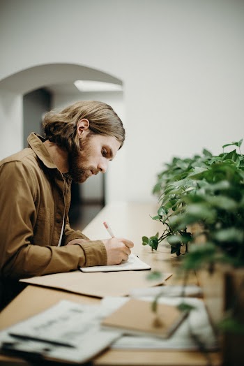Man Writing on Paper