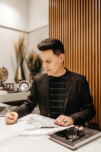 Man Writing on Table Inside Room
