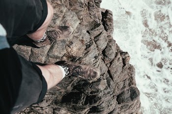 Mans Legs Over Cliff Ledge