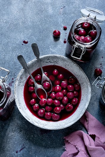 Maraschino cherry in a bowl and glass jar flat lay food photography