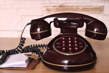 Maroon Push Button Telephone on Table