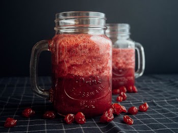 Mason Jar Filled With Cranberry Juice On Black and White Checked Cloth