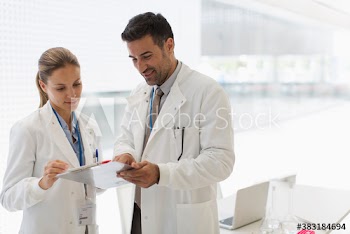 Medical scientists with clipboard in office