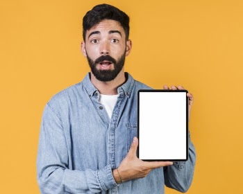 Medium shot surprised guy holding a tablet Free Photo