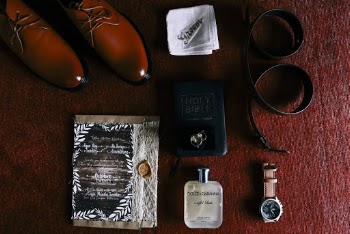 Men's Apparels and Bible on Red Textile