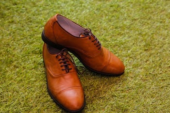 Men's Brown Leather Boat Shoes over Green Grass