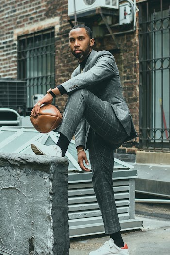 Men's Gray Suit Holding Brown Football