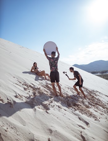 Men and Woman Shooting In The  Desert Sand