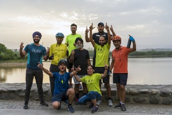 Men and Woman Taking Photo Together Beside Body of Water