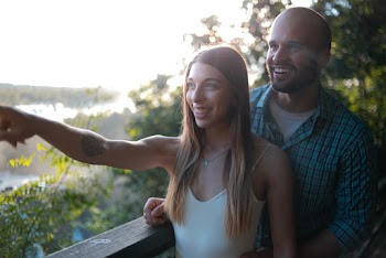 Men and Women in Balcony Near Trees