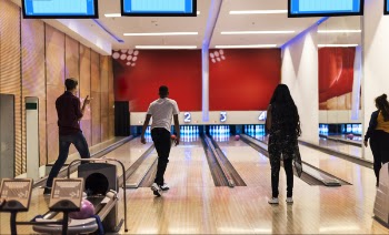 Men and Women Playing Bowling