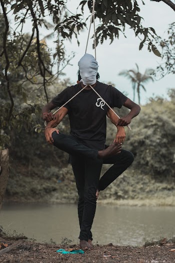 Men Balancing With Strings Near Body of Water
