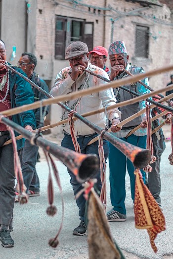 men blowing musical instrument