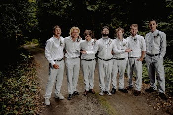 Men in gray trousers and white shirts standing on road 