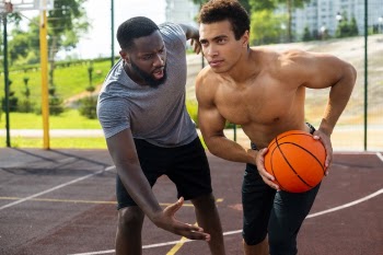 Men playing basketball long shot Free Photo