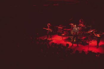 men playing instruments on stage