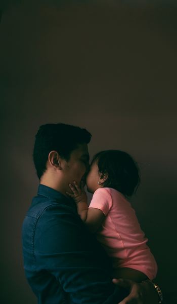 men's blue dress shirt and baby's pink shirt