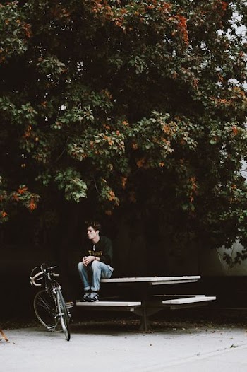 men sitting on picnic table