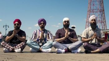 Men Sitting On The Ground While  Praying