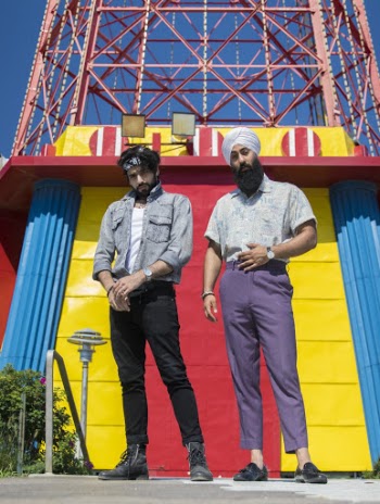 Men Standing Below A Tower