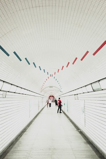 Men Walking Along Tunnel