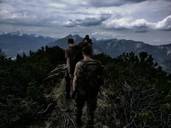men walking on top of mountain