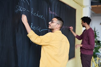 Men Writing on Board