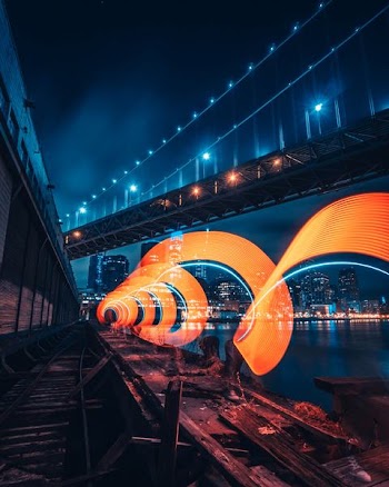 metal bridge near building during night time