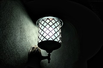 Metal Sconce Light Switched on during Night Time