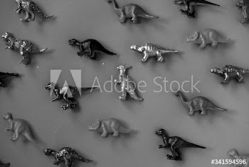 Metallic sprayed plastic diosaur figurine patterned background