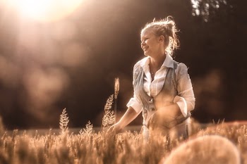 Mid Adult Woman in Wheat at Sunset