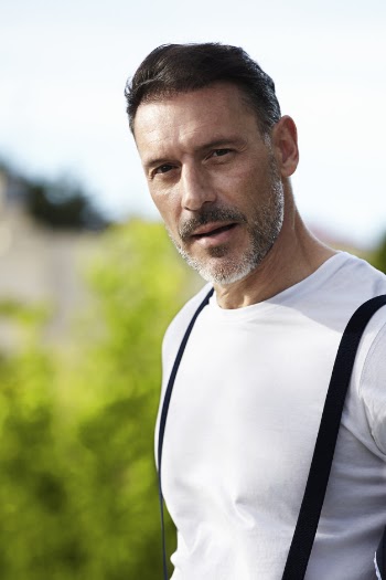 Middle-aged man wearing white shirt with suspenders Free Photo