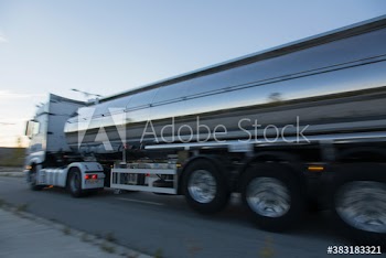Milk tanker driving on road