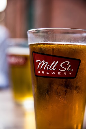 Mill St. Brewery Glass Filled With Yellow Liquid