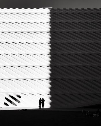 Miniature Of A White Concrete Building With People Outside
