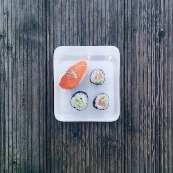 Minimal sushi on wooden background 