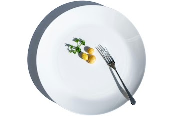 Minimalist Dining: Fork and Fresh Vegetables on a White Plate