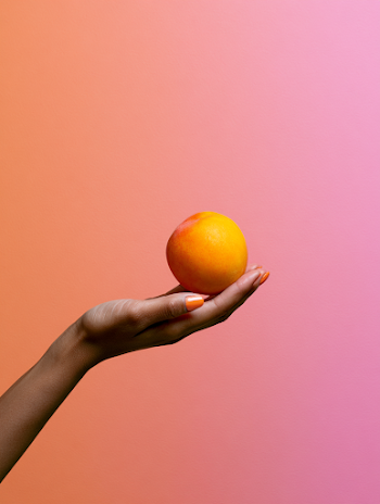 Minimalist Hand Holding Peach Fruit with Vibrant Background