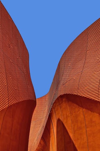 minimalist photography of brown wavy structure