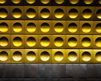 minimalist photography of gold and gray polka-dot wall