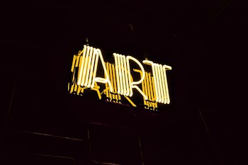 minimalist photography of yellow art neon light signage