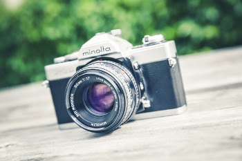 Minolta Grey and Grey Mcla on Grey Wooden Surface