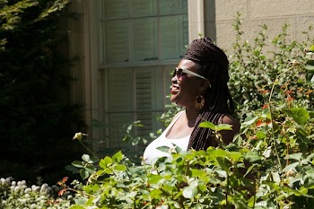 Model Poses And Smiles In Greenery