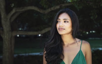 Model Poses In Green And Looks To Side