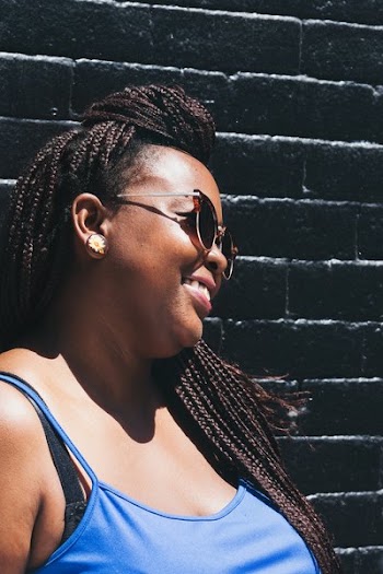 Model Smiles And Poses By Black Brick Wall
