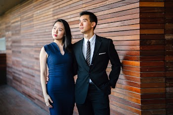 Models posing. an and Woman Standing Next to Each Other Looking Upward