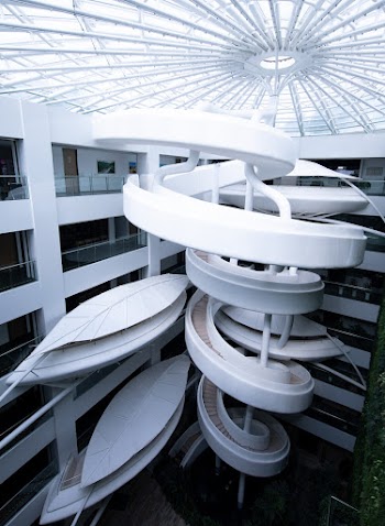 Modern Architectural Design Of A White Building With An Artistic Spiral Staircase
