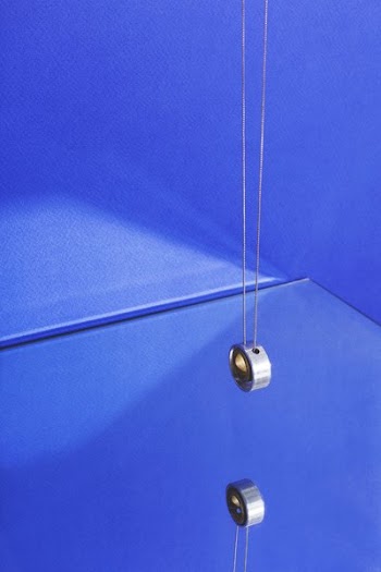 Modern Jewelry Hanging On Blue With Reflection