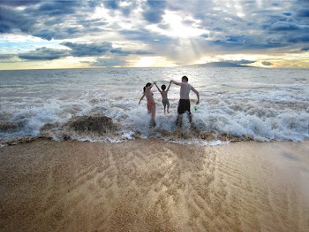 Mom, 3years old and Dad having fun in the waves