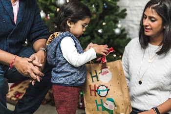 Mom and Dad Help Son Open Christmas Present
